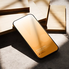 iPhone 16 Pro Mockup PSD On Wood In Bright Light