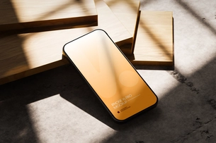 iPhone 16 Pro Mockup PSD On Wood In Bright Light