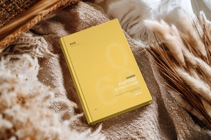 Free Hardcover Book Cover Mockup on Cozy Fabric Scene
