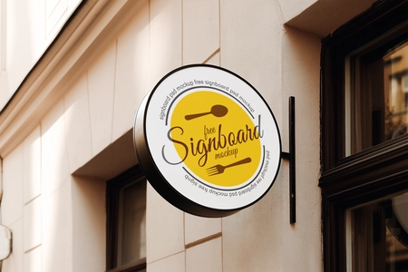 Free Round Cafe Sign Mockup on European Coffee Shop Facade