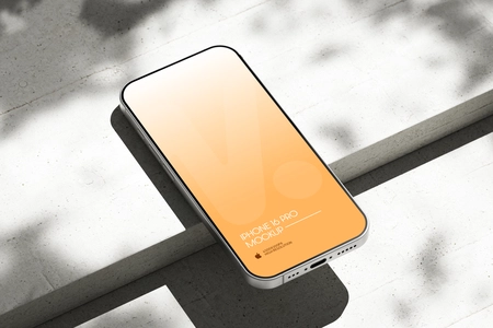 Free iPhone 16 Pro Mockup on Bright Concrete Surface with Shadows